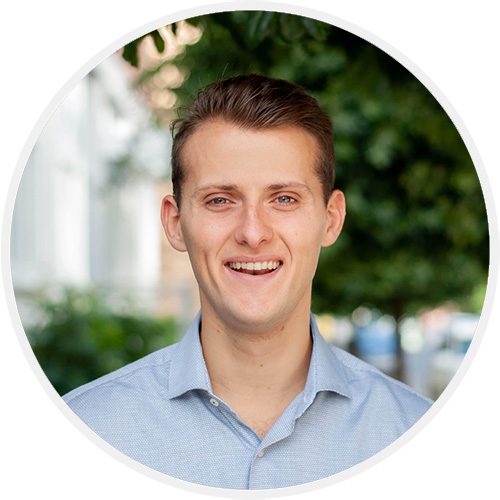 A man in blue shirt smiling for the camera.