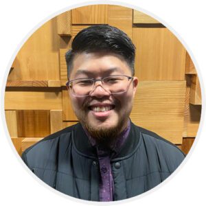 A man with glasses and a purple tie.